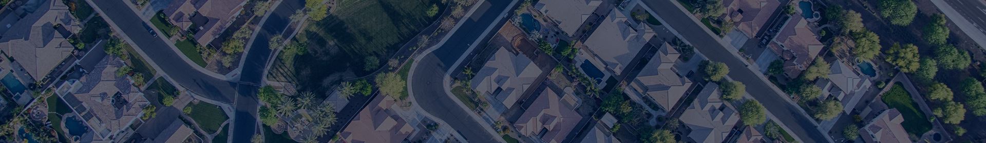 Aerial view of suburban neighborhood with houses and trees.